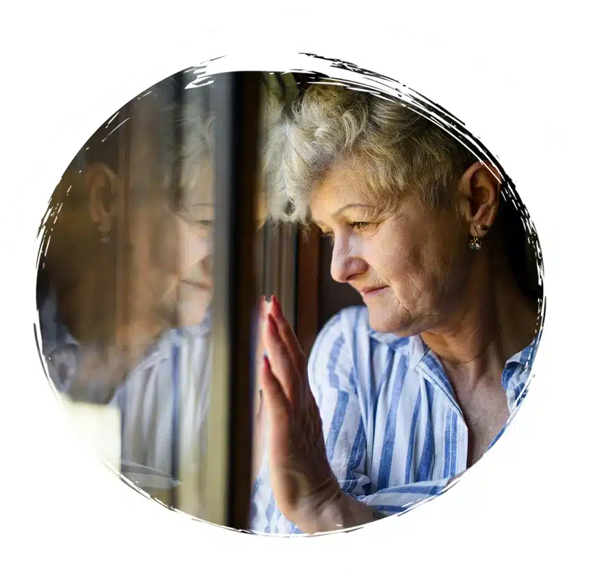 Woman standing in front of window on a sad mood